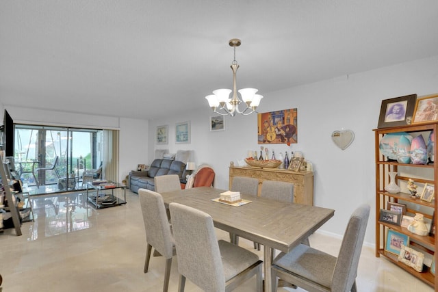 dining space featuring a chandelier and baseboards