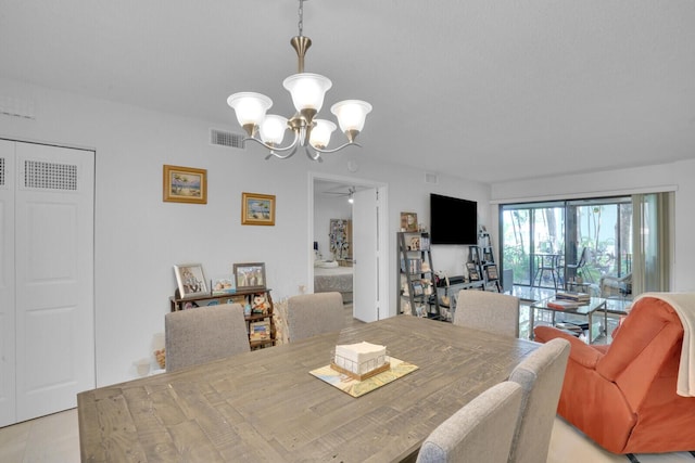 dining space featuring an inviting chandelier and visible vents