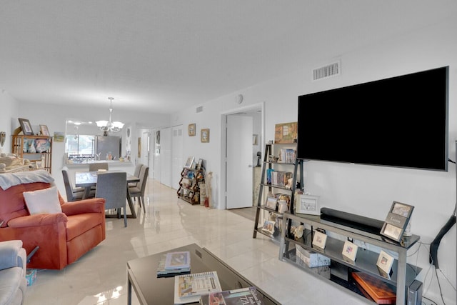 living area with visible vents and a notable chandelier