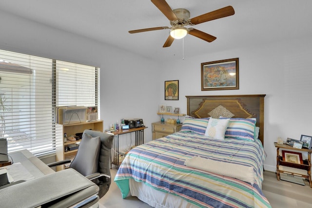 bedroom featuring ceiling fan and multiple windows