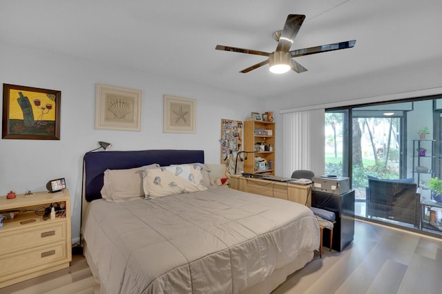 bedroom with ceiling fan, wood finished floors, and access to exterior