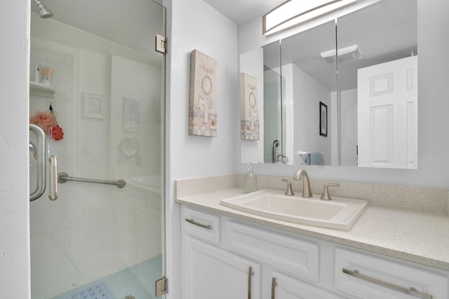 bathroom with a stall shower and vanity