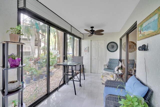 sunroom / solarium with a ceiling fan