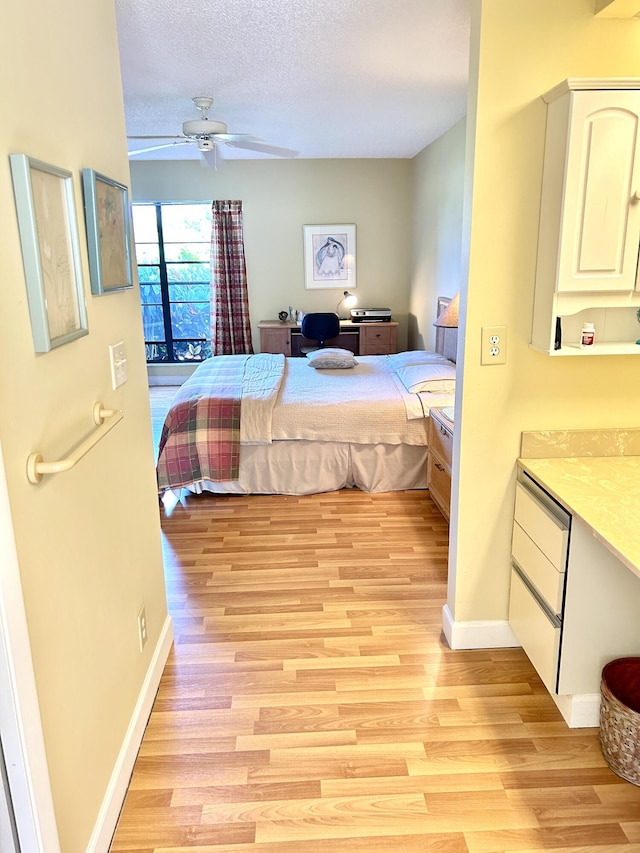 bedroom featuring baseboards, ceiling fan, access to outside, a textured ceiling, and light wood-type flooring