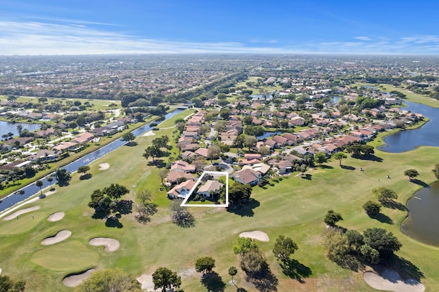 aerial view with a water view, view of golf course, and a residential view