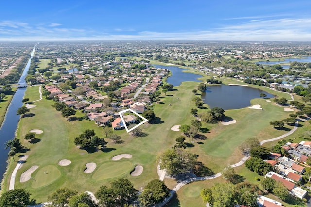 birds eye view of property featuring view of golf course and a water view