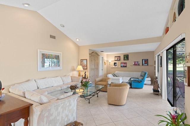 living area featuring light tile patterned floors, high vaulted ceiling, and visible vents