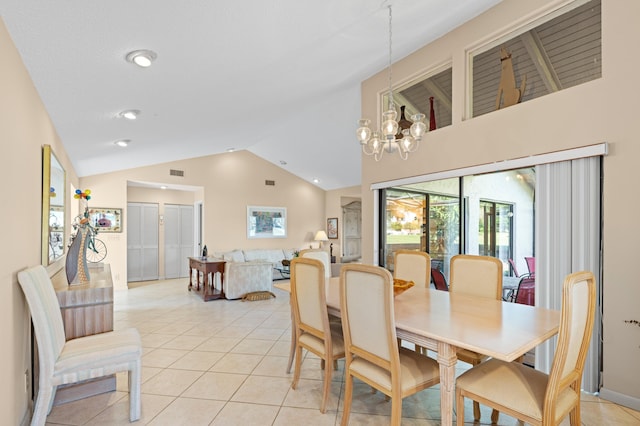 dining space with light tile patterned floors, high vaulted ceiling, visible vents, and an inviting chandelier