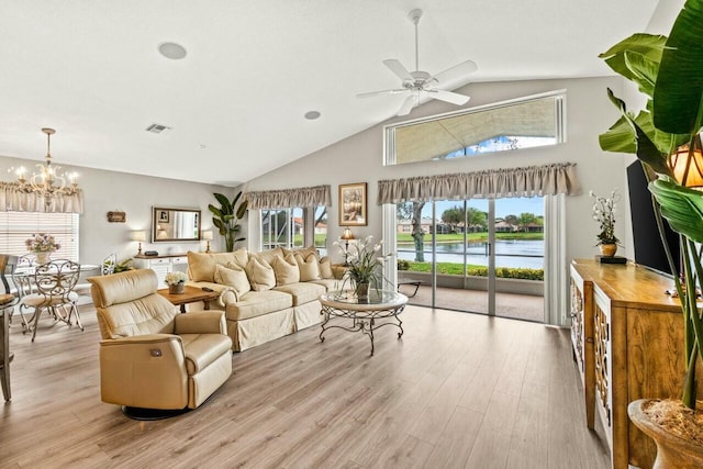 living room with visible vents, high vaulted ceiling, light wood-style flooring, and ceiling fan with notable chandelier