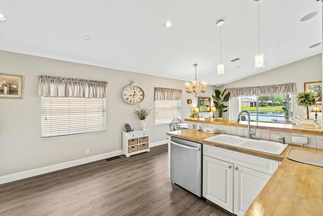 kitchen with decorative backsplash, stainless steel dishwasher, a sink, dark wood-style floors, and a notable chandelier