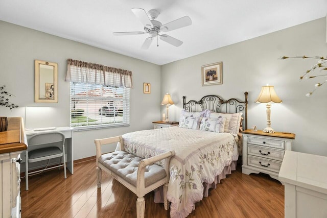 bedroom with baseboards, wood finished floors, and a ceiling fan