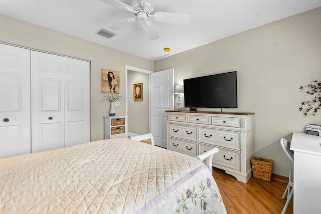 bedroom featuring light wood-style flooring, a closet, baseboards, visible vents, and a ceiling fan