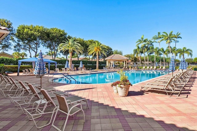community pool with a gazebo and a patio area