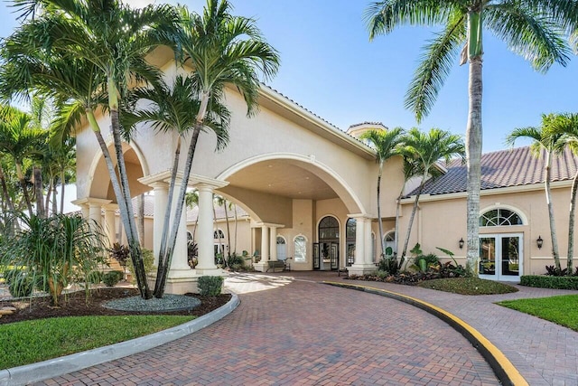 view of building exterior with curved driveway