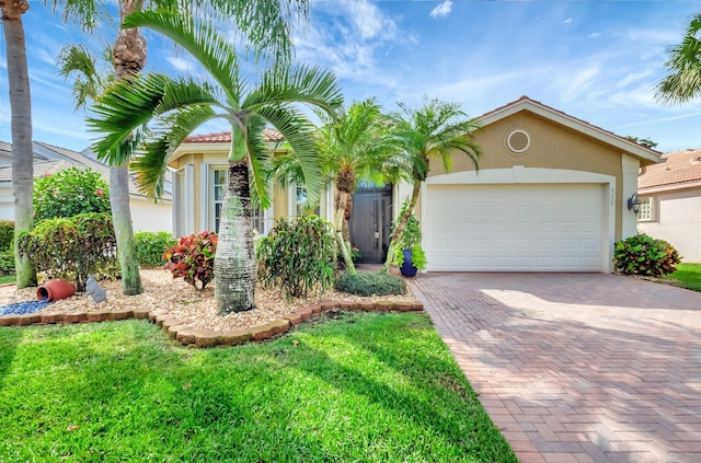 view of front of home with decorative driveway, an attached garage, and stucco siding