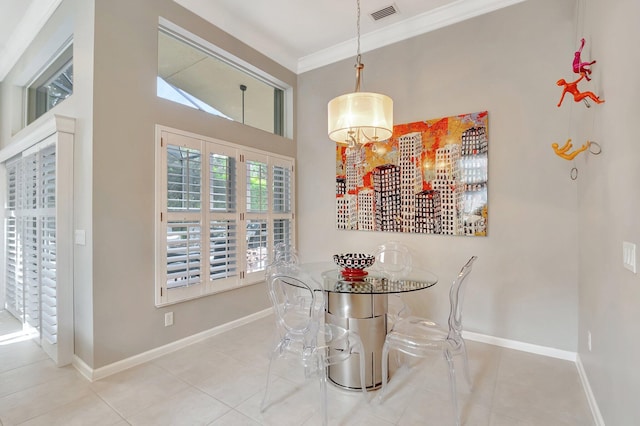 dining space featuring ornamental molding, visible vents, baseboards, and tile patterned floors