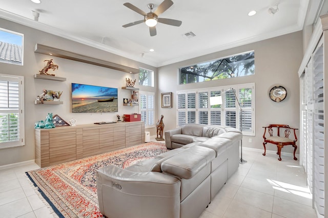 living room with light tile patterned floors, ornamental molding, and a healthy amount of sunlight