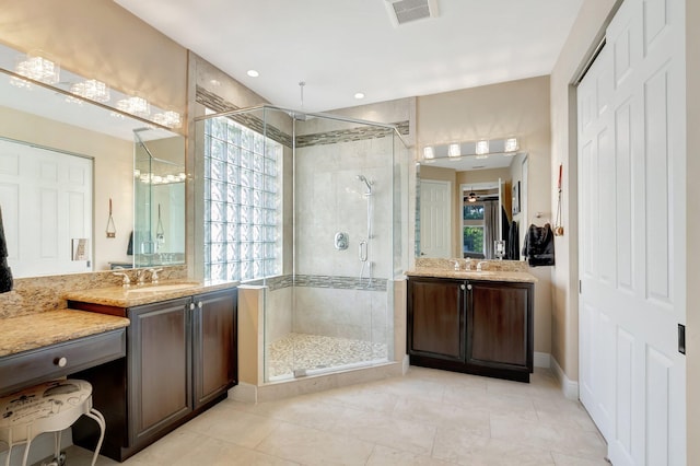 bathroom featuring a stall shower, a sink, and visible vents