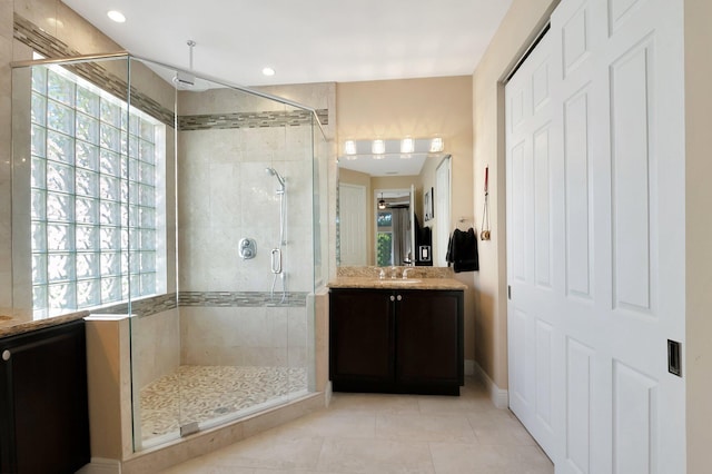 full bath with a stall shower, vanity, recessed lighting, and tile patterned floors