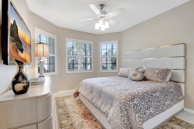 bedroom with baseboards and a ceiling fan