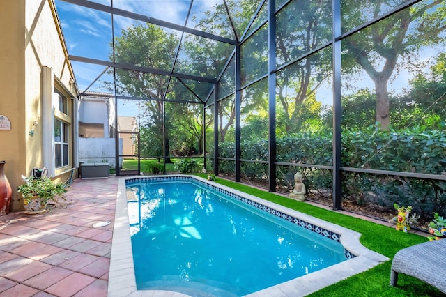 pool with glass enclosure and a patio area