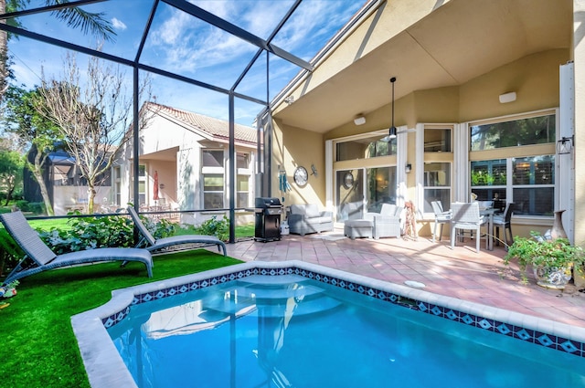 outdoor pool with glass enclosure, a grill, and a patio