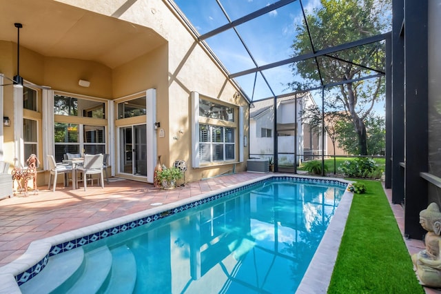 view of pool with a fenced in pool, glass enclosure, and a patio