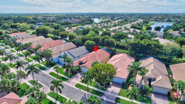 birds eye view of property with a water view and a residential view