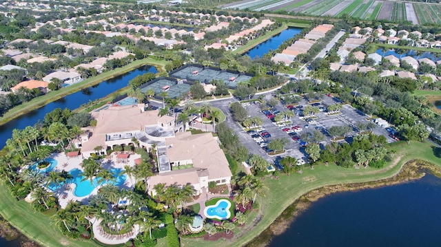 drone / aerial view with a water view and a residential view