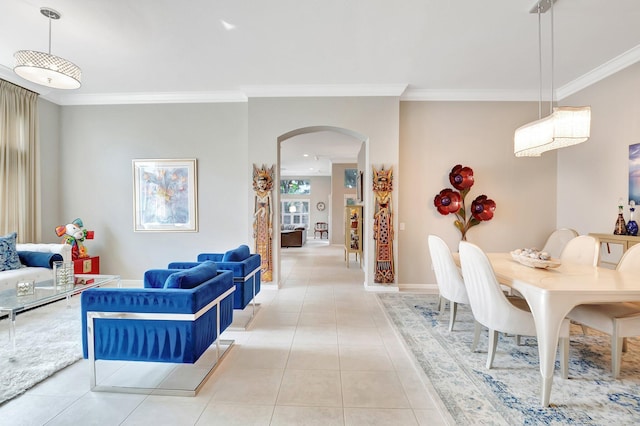 interior space featuring arched walkways, light tile patterned flooring, baseboards, and crown molding