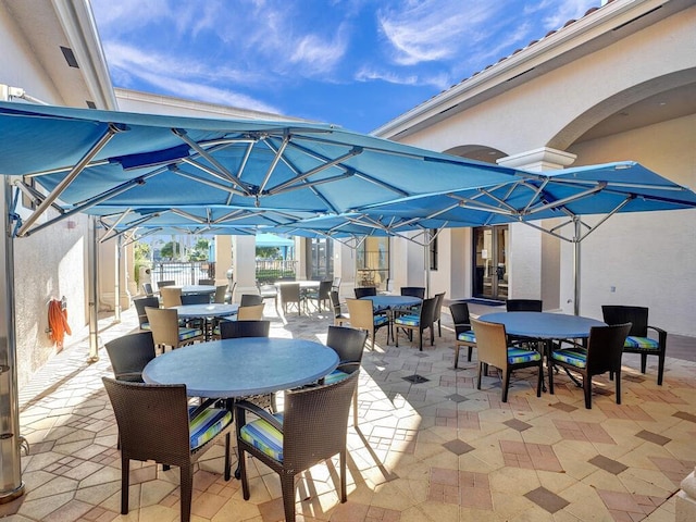 view of patio featuring fence and outdoor dining area