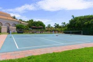 view of tennis court featuring fence