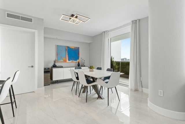 dining space with marble finish floor, visible vents, and baseboards