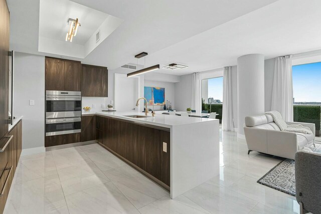 1180 N Federal Hwy Unit 1409, Fort Lauderdale, FL 33304 - kitchen featuring double oven, a sink, light countertops, open floor plan, and modern cabinets