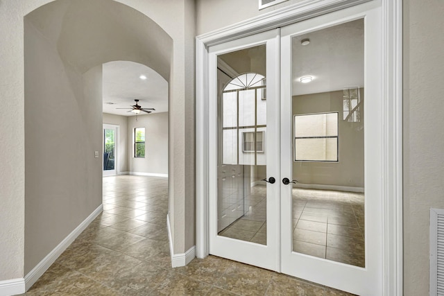 doorway to outside featuring french doors and ceiling fan