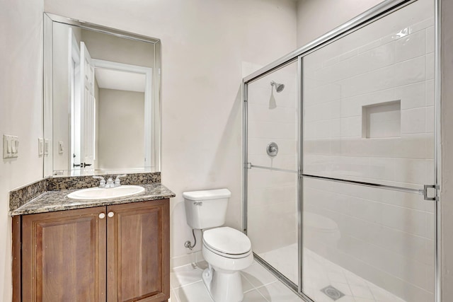 bathroom with vanity, toilet, and a shower with shower door