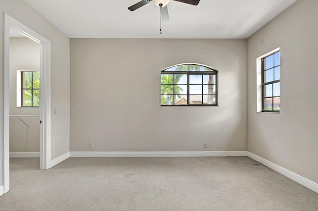 empty room featuring light carpet and ceiling fan