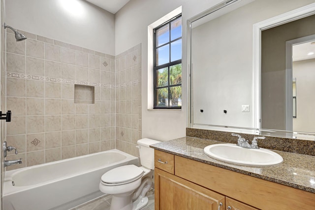 full bathroom with tiled shower / bath combo, vanity, and toilet