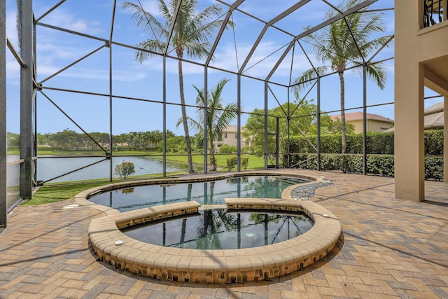 view of pool featuring an in ground hot tub, a water view, a lanai, and a patio area