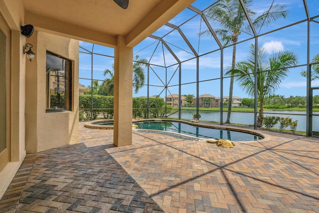 view of swimming pool with a water view, glass enclosure, a patio area, and a jacuzzi