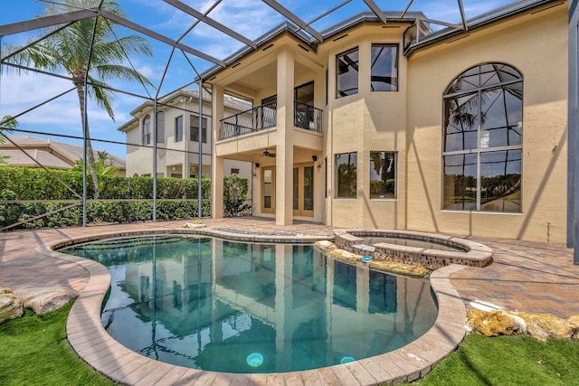 view of swimming pool with french doors, a patio area, an in ground hot tub, ceiling fan, and a lanai