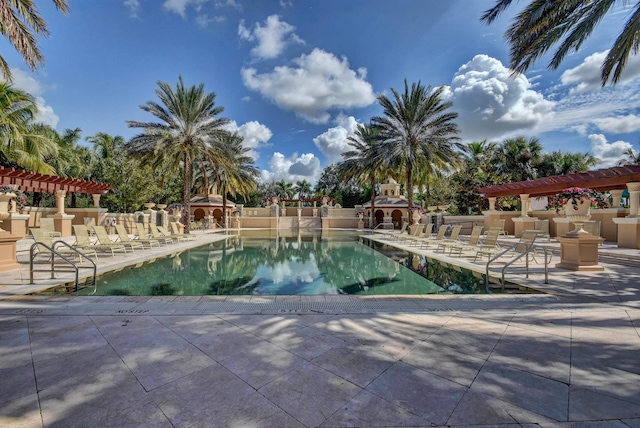 view of swimming pool featuring a patio and a pergola