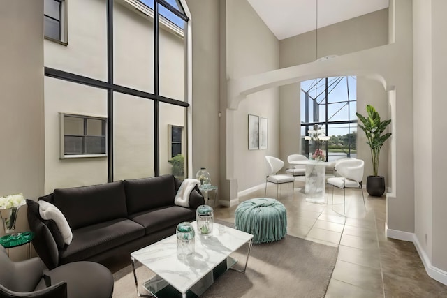 tiled living room with a high ceiling