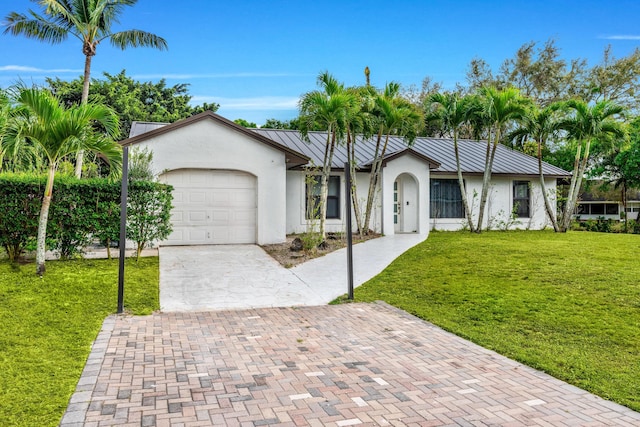 single story home with a garage and a front lawn