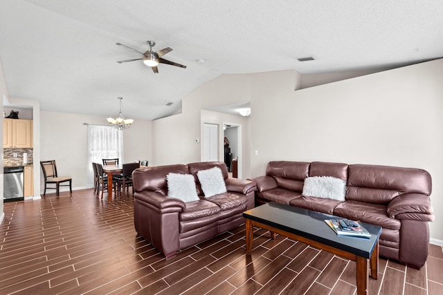 living room with ceiling fan with notable chandelier and vaulted ceiling