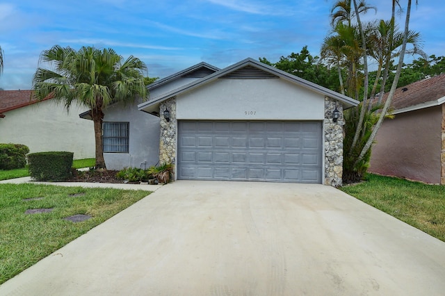 single story home with stucco siding, concrete driveway, a front yard, a garage, and stone siding