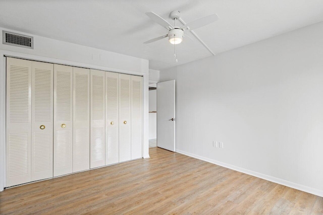 unfurnished bedroom with a ceiling fan, visible vents, baseboards, a closet, and light wood finished floors