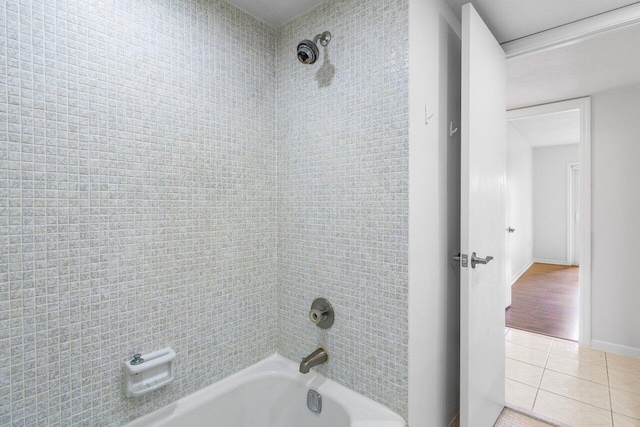 full bathroom featuring  shower combination, tile patterned flooring, and baseboards