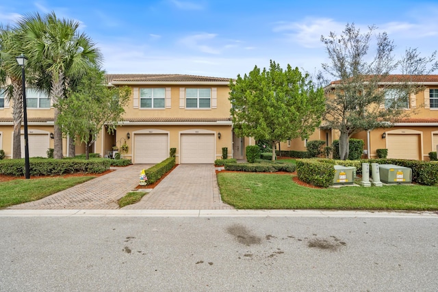 view of front of house with a garage and a front yard