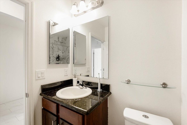 bathroom with toilet and vanity